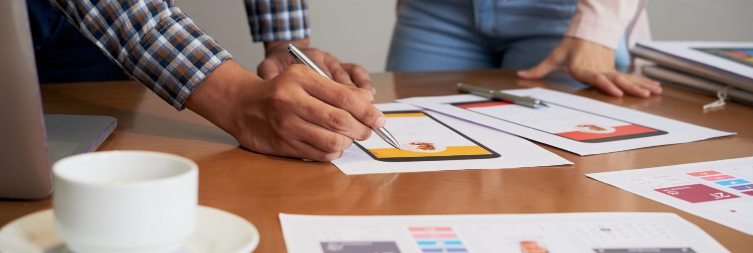 Hands of product manager making corrections on interface image